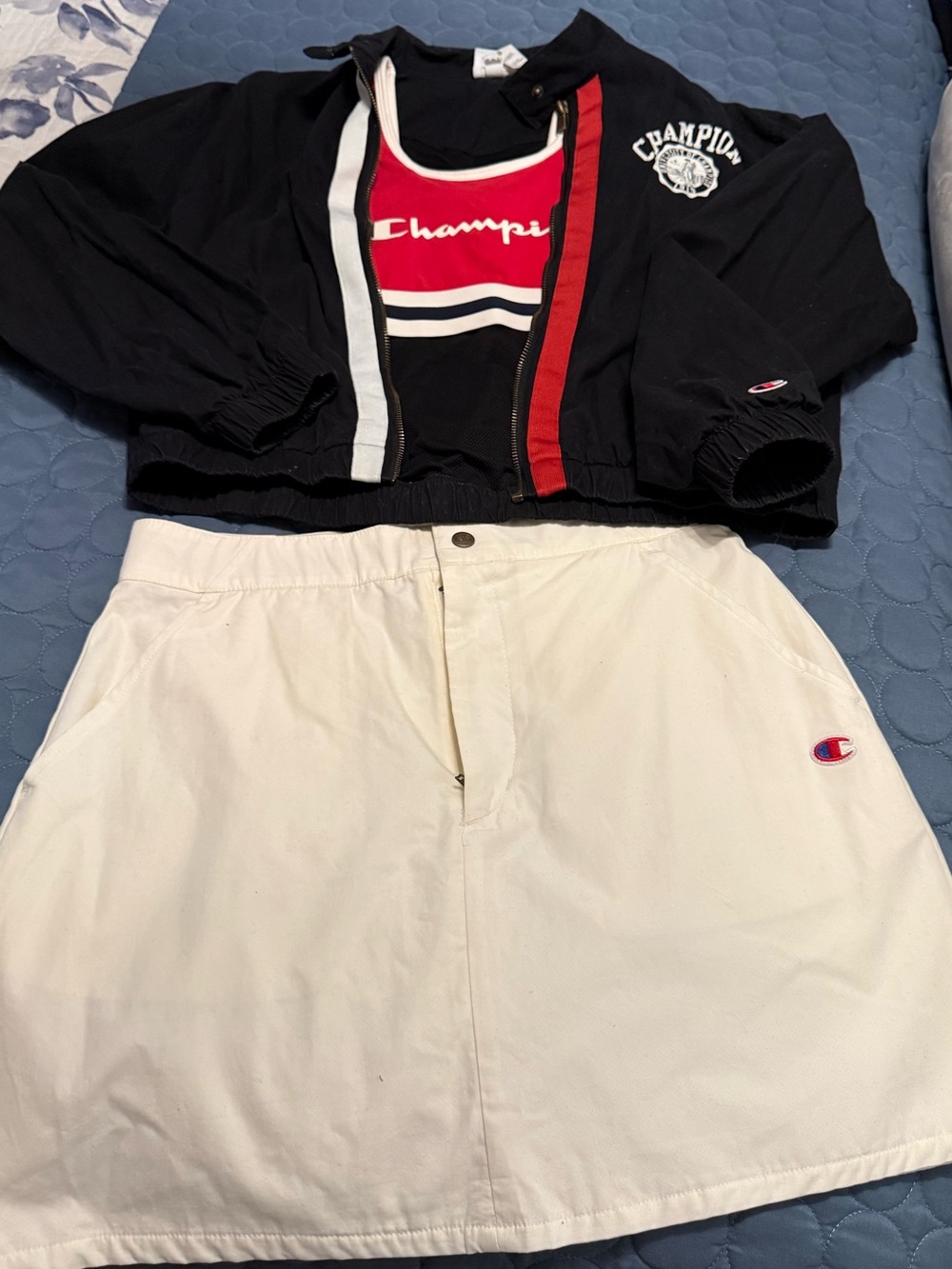 Champion Black Cropped Jacket with Red & White Trim and Cream Skirt & Sport bra